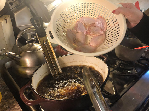 Buffalo Chicken Wings going into the oil